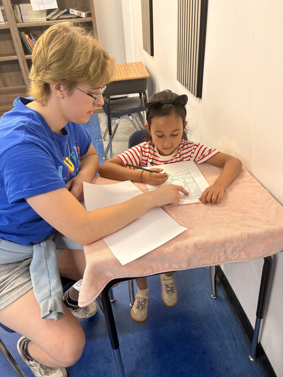 Camper happily drawing and crafting during bilingual summer camp activities
