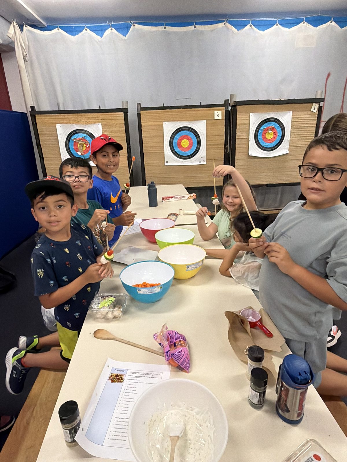 Young campers gathered around a table for a hands-on group activity at Laurus Summer Camp